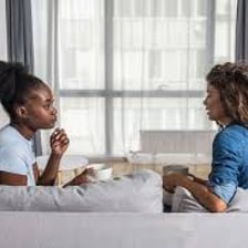 Two people having a friendly conversation and appearing comfortable together