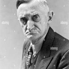 A person with a frowning expression that suggests irritability
