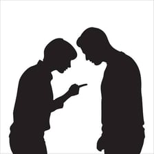 One person points toward another in an accusatory gesture.