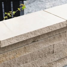 A finished masonry structure with a final stone placed on top
