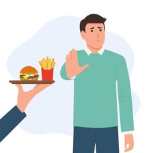 An illustration of a person deliberately avoiding junk food.