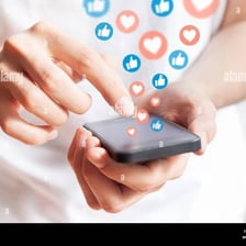 A person using a smartphone to share a social media post.