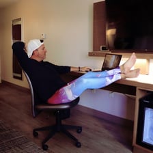 A person wearing leggings while working at home.