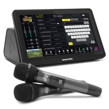 A person singing into a microphone while following lyrics on a karaoke screen.