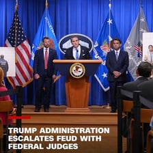 A speaker addressing reporters at a press conference.