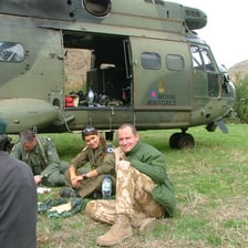 A service member answering questions during a post-mission debriefing