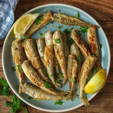 Several small cooked smelt fish served whole