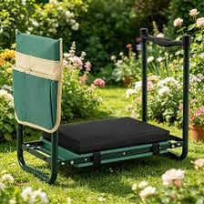 A padded kneeler placed beside a garden bed for someone working on their knees.