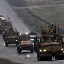 Vehicles leaving an area during a military withdrawal.