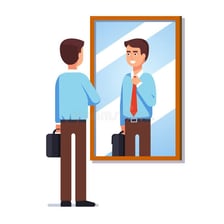 A person admiring their reflection in a mirror