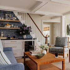 A person adding decorative touches to improve a room’s appearance.