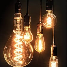 Several lamps and bulbs providing illumination in a room