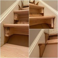 A visibly worn wooden staircase with aged boards and railings