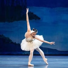 Ballet dancers wearing traditional tutus on stage