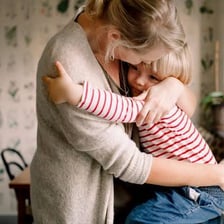 A parent providing attentive care to a child