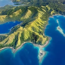 Aerial view of Fiji’s tropical islands and surrounding blue water.