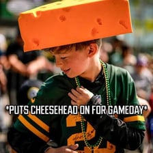A Wisconsin sports fan wearing a foam cheese-shaped hat