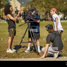 A film crew recording a movie scene with a camera