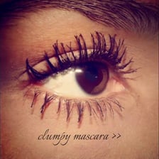 Close-up of eyelashes with mascara gathered into visible clumps
