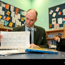 Teacher evaluating student exam papers