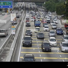 Traffic slowing where multiple lanes merge into a narrow roadway.