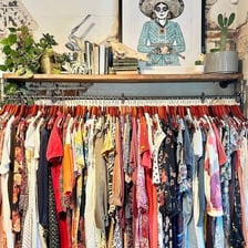 Used clothing and other goods displayed for resale in a consignment shop.