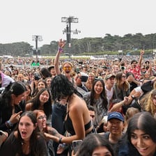 A crowd gathered at an outdoor music festival.