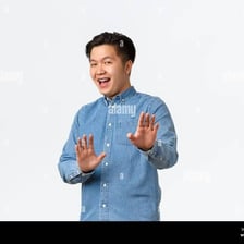 A person making an emphatic refusal gesture with a raised hand