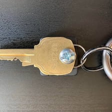 A cluster of metal keys and chain links associated with a jangling metallic sound.