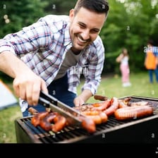 A person grilling food on an outdoor barbecue.