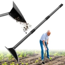 A landscaper cultivating soil with a garden hoe