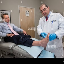 A podiatrist examining a patient’s foot in a medical clinic