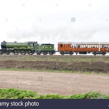 A locomotive pulling a train along railway tracks