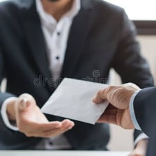 A worker holding a paycheck.