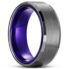A dark gray metal surface with a faint bluish-purple tint.
