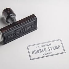 A rubber stamp creating a visible imprint on a sheet of paper