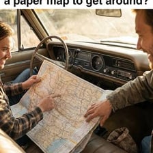 A person opening a folded paper map.