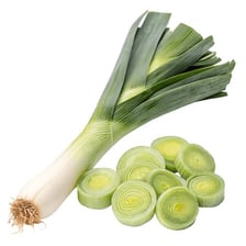 A fresh leek with its white stalk and green leaves, shown whole and sliced