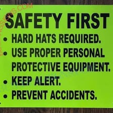 A workplace notice requiring workers to wear hard hats.