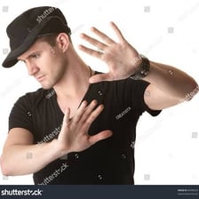 A person waving a hand to shoo away a fly.