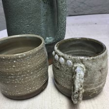A handmade ceramic object showing visible imperfections.