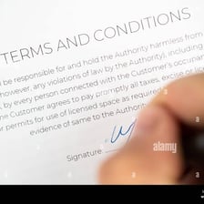 A person reviewing or signing a document containing terms and conditions