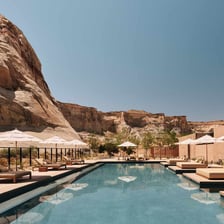 A tranquil spa resort with a pool and treatment area.