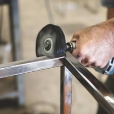 A person polishing a metal surface until it shines.