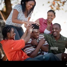 Friends sharing a playful, lighthearted moment outdoors.