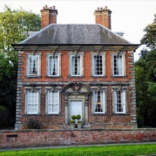 A Georgian-style house showing a dormer window projecting from the roof.