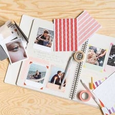 An open scrapbook displaying photographs, captions, and memorabilia.
