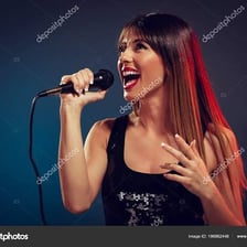 A singer holding a microphone while performing on stage.