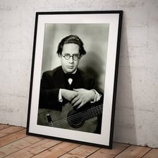 Andrés Segovia holding a classical guitar.