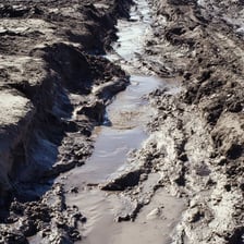 Waterlogged muddy ground after heavy rain.